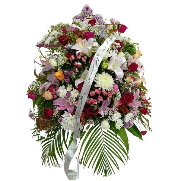 Floral Fantasy flower stand with red and pink roses, white lilies, pink chrysanthemums, and baby’s breath, perfect for weddings, anniversaries, and celebrations.