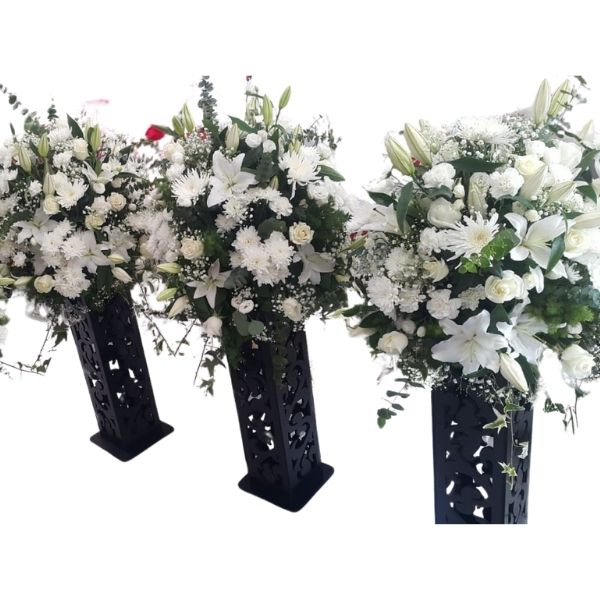 Classic Conference Bloom with white lilies, chrysanthemums, and baby’s breath in a sleek black floral stand for corporate events and conferences.