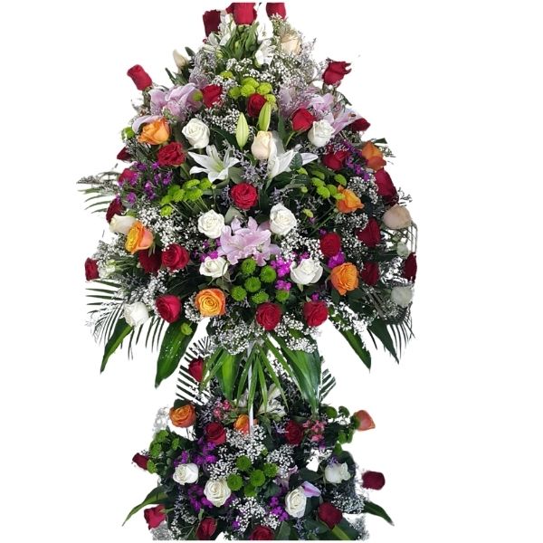 Floral Glory Stand with red, white, pink, and orange roses, white lilies, purple flowers, and baby’s breath in a vibrant floral arrangement for grand events and celebrations.