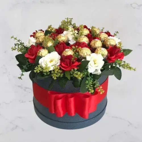 Roses & Chocolate Charm – Round box filled with red and white roses and Ferrero Rocher chocolates, finished with a red ribbon.